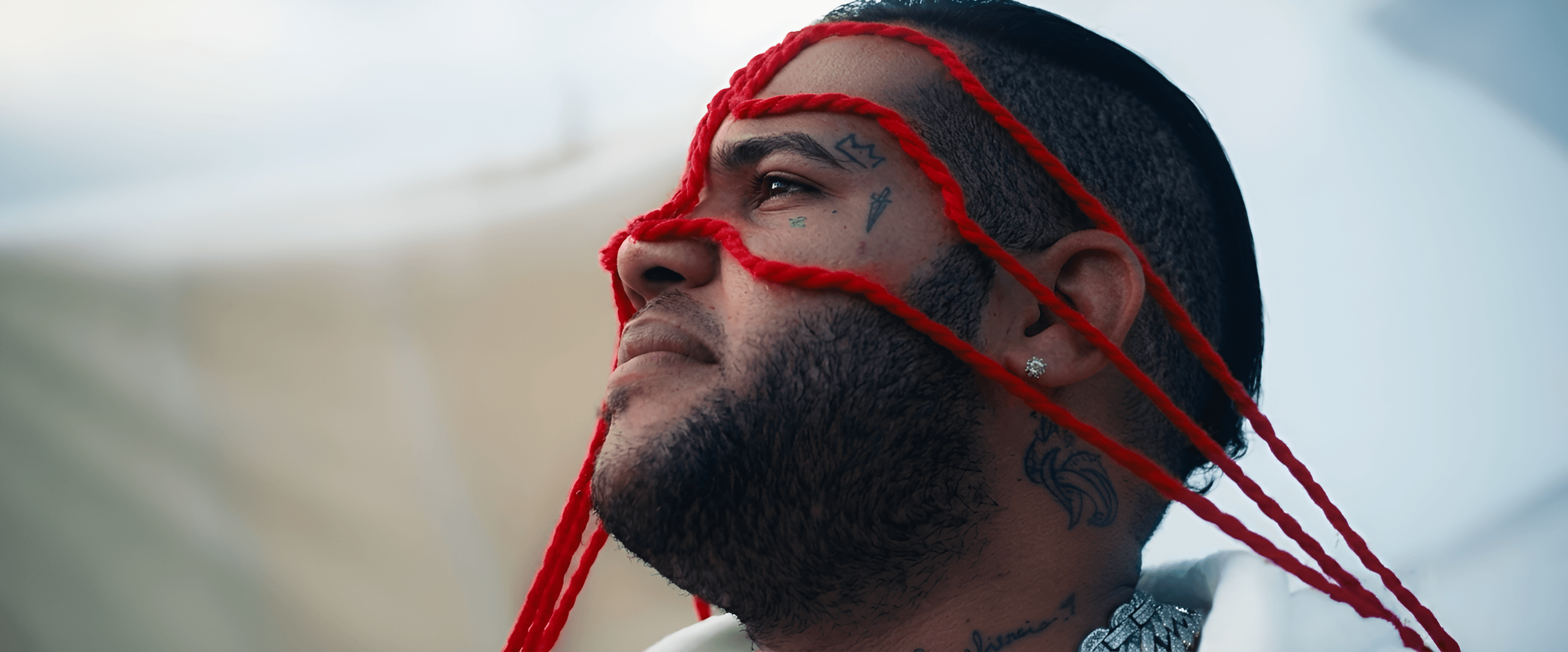 AI Image Enhancer: Upscale Details for Man with Red Threads & Tattoos