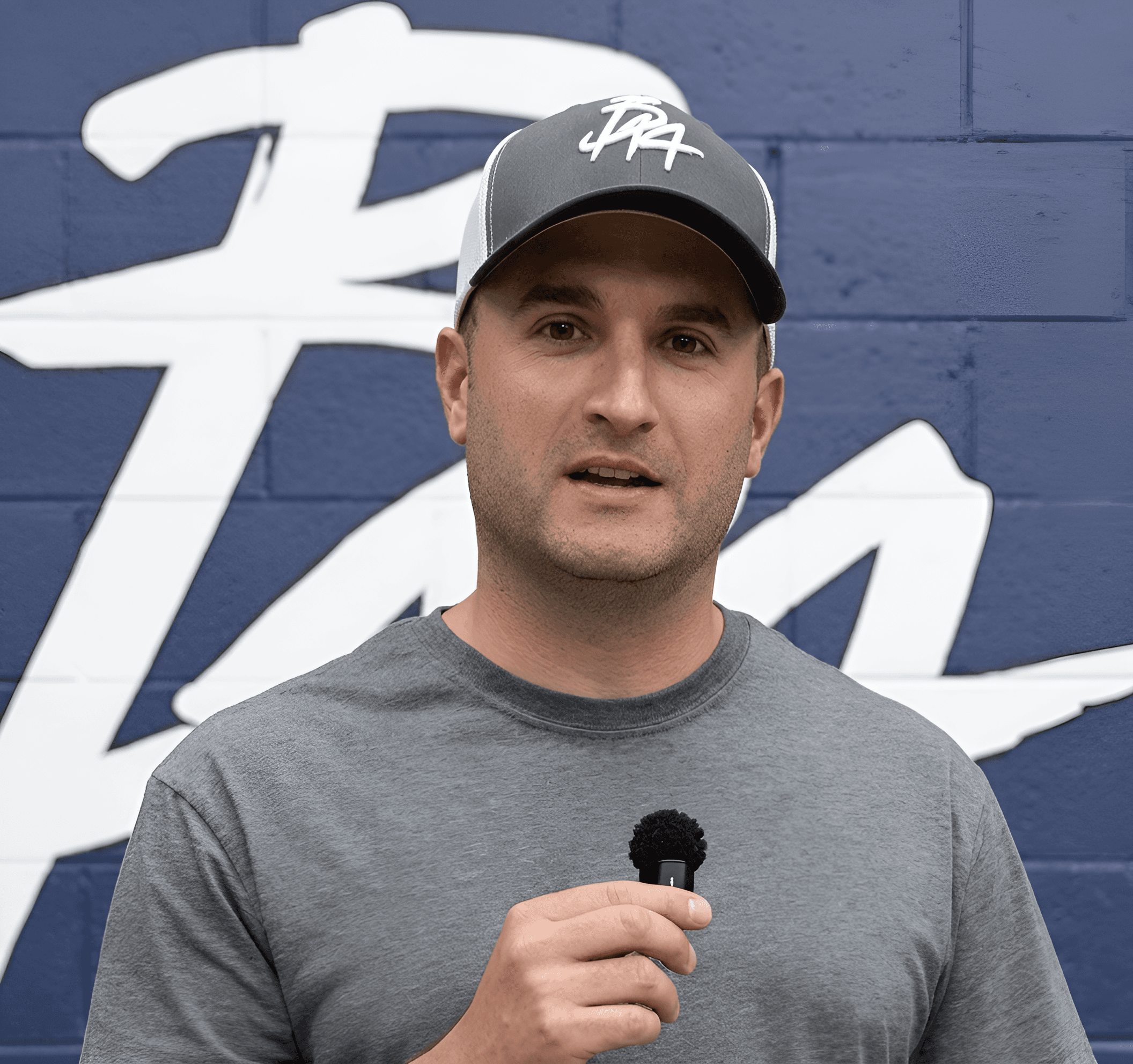 Upscale & Sharpen Video Still of Man with Mic | BgRemovit AI